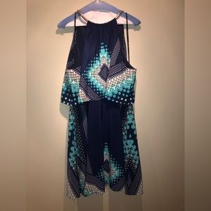 Fit and flair halter dress, metal neckline, flutter top.